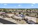 Aerial view of the home with solar panels in a neighborhood with mountains in the distance at 10809 W Harmony Ln, Peoria, AZ 85373