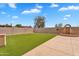 Spacious backyard featuring artificial turf, a water feature, and privacy walls at 10809 W Harmony Ln, Peoria, AZ 85373