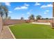 Lush backyard featuring artificial turf and a sparkling pool with a fountain, creating a serene outdoor oasis at 10809 W Harmony Ln, Peoria, AZ 85373