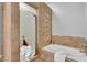 Bathroom with shower and soaking tub with decorative tile and neutral-toned walls at 10809 W Harmony Ln, Peoria, AZ 85373