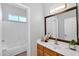 Bathroom vanity featuring sink, mirror and plant decoration at 10809 W Harmony Ln, Peoria, AZ 85373