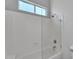 An alcove tub and shower with glass door is featured in this bathroom at 10809 W Harmony Ln, Peoria, AZ 85373