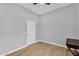 A gray bedroom with wood floors, a door, and desk at 10809 W Harmony Ln, Peoria, AZ 85373
