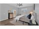 Bright bedroom with wood-style floors and a large window with shutters at 10809 W Harmony Ln, Peoria, AZ 85373