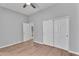 This is a gray bedroom with wood floors, closet and a door way at 10809 W Harmony Ln, Peoria, AZ 85373