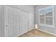 A bright bedroom featuring closet and shuttered windows at 10809 W Harmony Ln, Peoria, AZ 85373