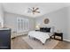 Spacious bedroom features plantation shutters, wood floors, and a cozy rug at 10809 W Harmony Ln, Peoria, AZ 85373