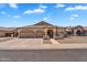 Traditional single-story home features desert landscaping, and a three-car garage at 10809 W Harmony Ln, Peoria, AZ 85373