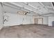 A large garage with cabinet, sink, water heater, and two overhead garage doors at 10809 W Harmony Ln, Peoria, AZ 85373