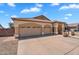Exterior view of a home with three-car garage, desert landscaping, and a driveway at 10809 W Harmony Ln, Peoria, AZ 85373