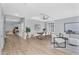 Spacious living and dining area with wood floors, updated furnishings, and natural light at 10809 W Harmony Ln, Peoria, AZ 85373