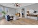 Comfortable living room with modern decor, a ceiling fan, and hardwood floors throughout at 10809 W Harmony Ln, Peoria, AZ 85373
