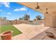 Covered patio overlooking a backyard pool with a fountain, offering a relaxing outdoor entertainment space at 10809 W Harmony Ln, Peoria, AZ 85373