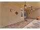 Covered back patio with two ceiling fans and access to the backyard at 10809 W Harmony Ln, Peoria, AZ 85373