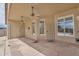 Covered patio with two ceiling fans and two doors leading to the backyard at 10809 W Harmony Ln, Peoria, AZ 85373