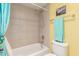 Clean bathroom featuring a shower-tub combo with tiled walls, a toilet, and a towel rack at 1111 W Summit Pl # 85, Chandler, AZ 85224