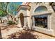 Exterior view featuring a well-kept stucco facade, red tiled roof, arched entryway and mature landscaping at 1111 W Summit Pl # 85, Chandler, AZ 85224