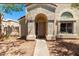 Inviting front entrance of the property features desert landscaping, an arched entryway, and a large window at 1111 W Summit Pl # 85, Chandler, AZ 85224