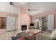 Bright living room with a fireplace, a ceiling fan, and a sliding glass door leading to outdoor space at 1111 W Summit Pl # 85, Chandler, AZ 85224
