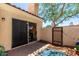 Private patio featuring a sliding glass door, outdoor lighting, and a gated entrance at 1111 W Summit Pl # 85, Chandler, AZ 85224