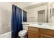 Bathroom featuring a shower and tub combo, wooden vanity, and a large mirror at 11429 W Yavapai St, Avondale, AZ 85323
