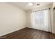 Neutral toned bedroom offers abundant natural light and soft sheer curtains at 11429 W Yavapai St, Avondale, AZ 85323