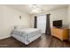 Cozy bedroom features a queen bed, ceiling fan, and natural lighting at 11429 W Yavapai St, Avondale, AZ 85323