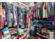 A walk-in closet is filled with clothes and shoe boxes at 11429 W Yavapai St, Avondale, AZ 85323