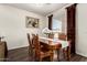 Cozy dining room featuring wood floors, a wooden table with seating for four, and natural light at 11429 W Yavapai St, Avondale, AZ 85323