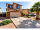 Charming two-story home with a spacious driveway, desert landscaping, and an attached two-car garage at 11429 W Yavapai St, Avondale, AZ 85323