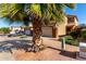 Desert home with palm tree, desert landscaping, two-car garage and spacious driveway at 11429 W Yavapai St, Avondale, AZ 85323