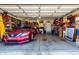 Spacious garage with ample storage space, housing a modern red sedan at 11429 W Yavapai St, Avondale, AZ 85323