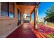 A covered patio features a charming seating area and overlooks a well-maintained backyard at 11429 W Yavapai St, Avondale, AZ 85323