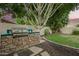 Outdoor kitchen with built-in grill, surrounded by lush landscaping at 1181 N Dustin Ln, Chandler, AZ 85226