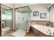 Bathroom featuring a glass shower and a soaking tub with tile surround at 1181 N Dustin Ln, Chandler, AZ 85226