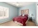 Cozy bedroom featuring light blue walls, white shuttered window, and a plush velvet bed at 1181 N Dustin Ln, Chandler, AZ 85226