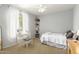 Bright bedroom with neutral tones, a large window, and decor shelving at 1181 N Dustin Ln, Chandler, AZ 85226