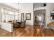 Elegant dining room featuring hardwood floors, a stylish chandelier, and open access to other living areas at 1181 N Dustin Ln, Chandler, AZ 85226