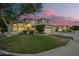 Charming two-story home with a lush lawn, mature landscaping, and a three-car garage at 1181 N Dustin Ln, Chandler, AZ 85226