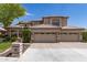 Stunning two-story home featuring a three-car garage, tile roof, and well-maintained landscaping at 1181 N Dustin Ln, Chandler, AZ 85226
