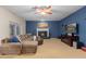 Comfortable living room with fireplace, ceiling fan, and large sectional sofa at 1181 N Dustin Ln, Chandler, AZ 85226