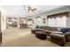 Spacious living area with comfortable seating, a ceiling fan, and seamless flow to the kitchen at 1181 N Dustin Ln, Chandler, AZ 85226