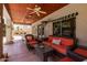 Relaxing outdoor patio with comfortable seating, ceiling fans, and view of the backyard at 1181 N Dustin Ln, Chandler, AZ 85226