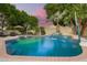 Beautiful pool featuring a waterfall and mature landscaping, perfect for relaxation and entertainment at 1181 N Dustin Ln, Chandler, AZ 85226