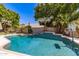 Inviting backyard pool with waterfall feature, surrounded by lush landscaping at 1181 N Dustin Ln, Chandler, AZ 85226