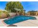 Inviting backyard pool with waterfall feature, surrounded by lush landscaping and a covered patio area at 1181 N Dustin Ln, Chandler, AZ 85226