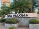 Entrance sign to Casa Paloma, featuring stone accents and manicured landscaping at 1181 N Dustin Ln, Chandler, AZ 85226