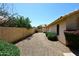 Backyard features neutral desert landscape and a partial view of the home's exterior at 1212 W Vera Ln, Tempe, AZ 85284