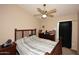 Comfortable bedroom with a ceiling fan, a dresser, and a large window providing a cozy and relaxing atmosphere at 1212 W Vera Ln, Tempe, AZ 85284