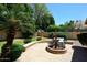 Backyard fountain surrounded by mature trees, lush lawn, and well manicured landscaping at 1212 W Vera Ln, Tempe, AZ 85284